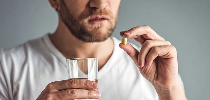 A man takes medication to treat prostatitis